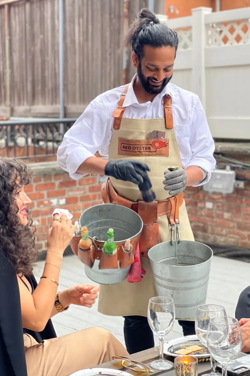 Chef serving oysters on the terrace
