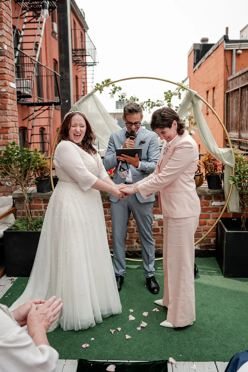 Couple exchanging vows at a small ceremony on the Green Boutique terrace