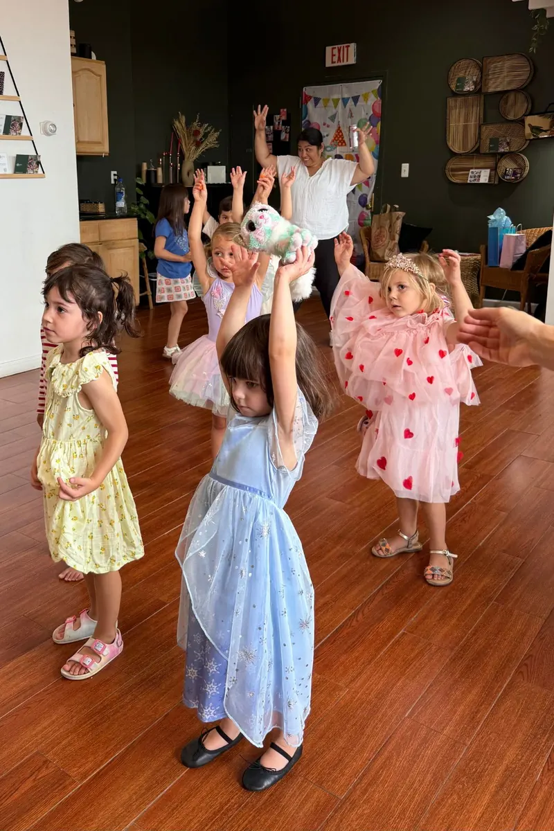 Children dancing with their arms up