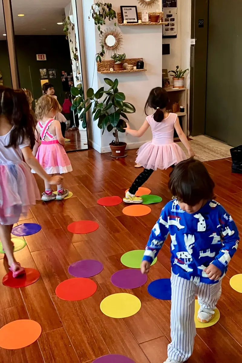 Children playing on colorful floor dots