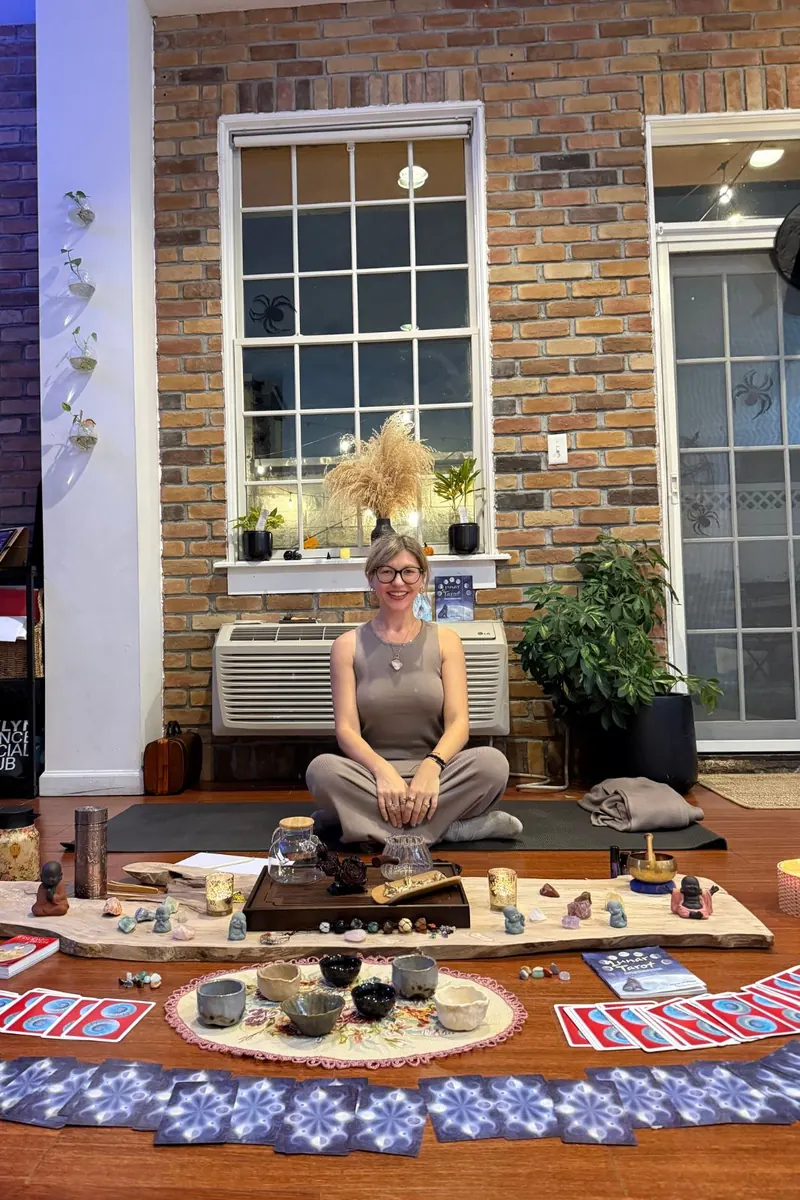 Women's circle seating area with candles, crystals and oracle cards