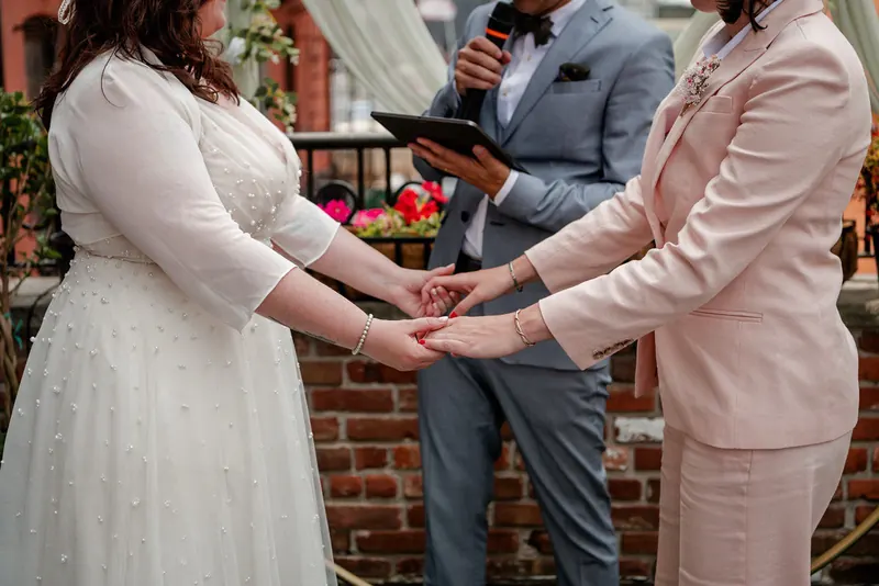 Couple holding hands during their micro wedding ceremony